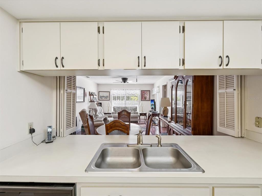 12141 Spartan Way, Unit 202 Hudson, FL 34667 - Photo 15 of 45 a view of a kitchen with kitchen island a sink and a stove with wooden floor