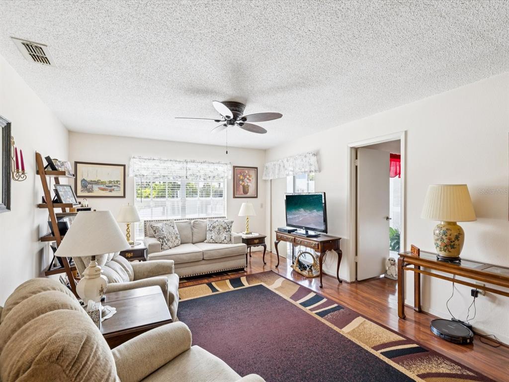 12141 Spartan Way, Unit 202 Hudson, FL 34667 - Photo 16 of 45 a living room with furniture and a flat screen tv
