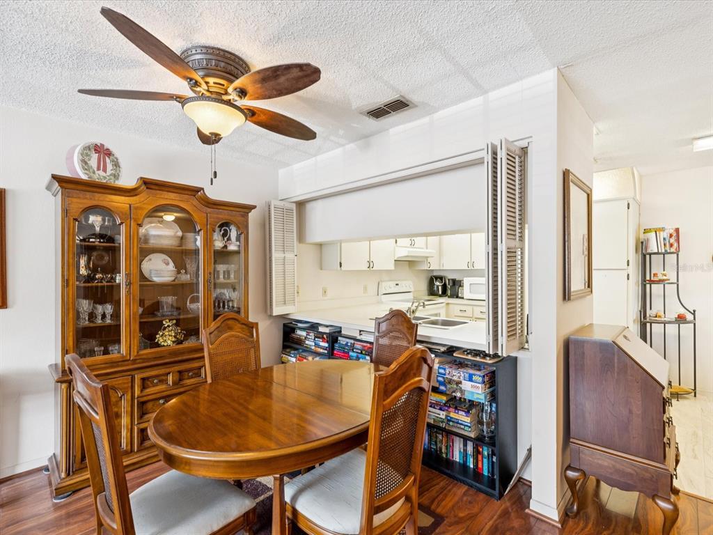 12141 Spartan Way, Unit 202 Hudson, FL 34667 - Photo 17 of 45 a view of a dining room with furniture window and wooden floor
