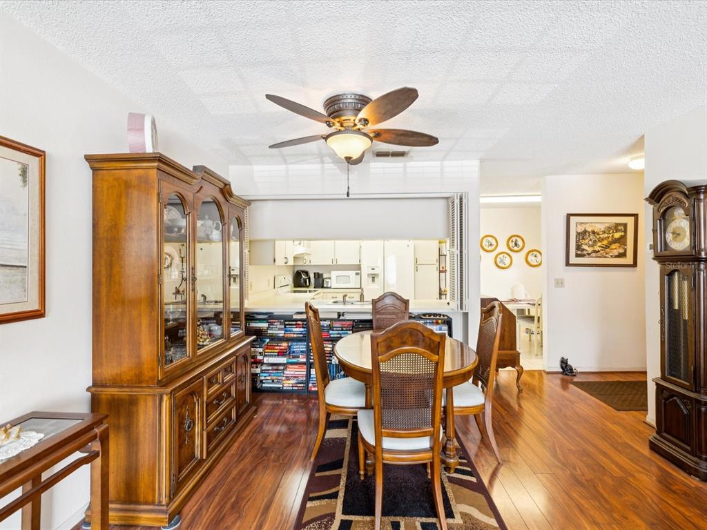 12141 Spartan Way, Unit 202 Hudson, FL 34667 - Photo 18 of 45 a view of a dining room with furniture window and wooden floor