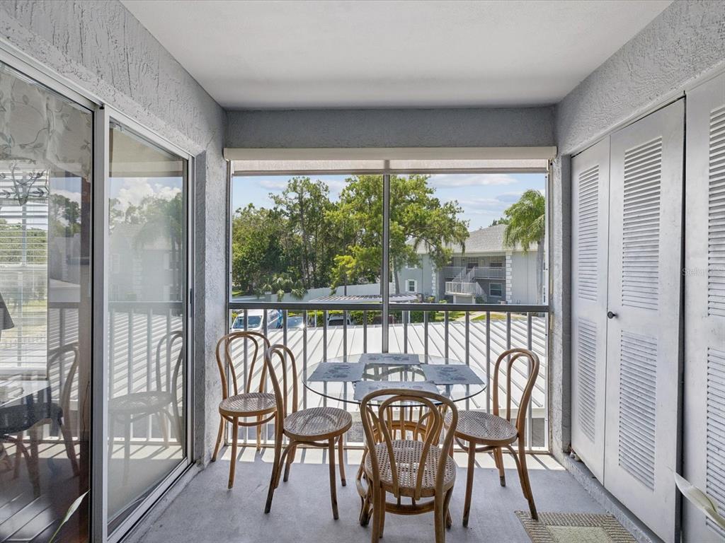 12141 Spartan Way, Unit 202 Hudson, FL 34667 - Photo 23 of 45 a view of a chairs and table in the balcony