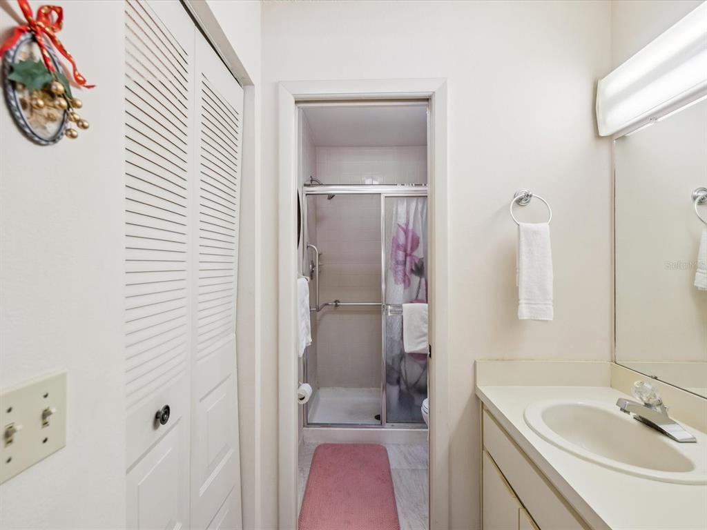 12141 Spartan Way, Unit 202 Hudson, FL 34667 - Photo 26 of 45 a bathroom with a tub sink and mirror