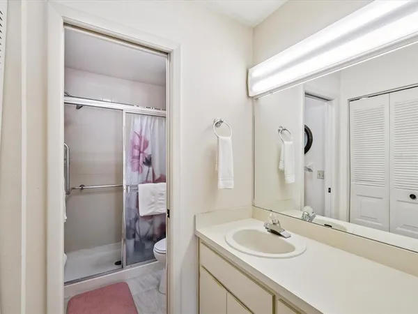 a bathroom with a shower and a mirror