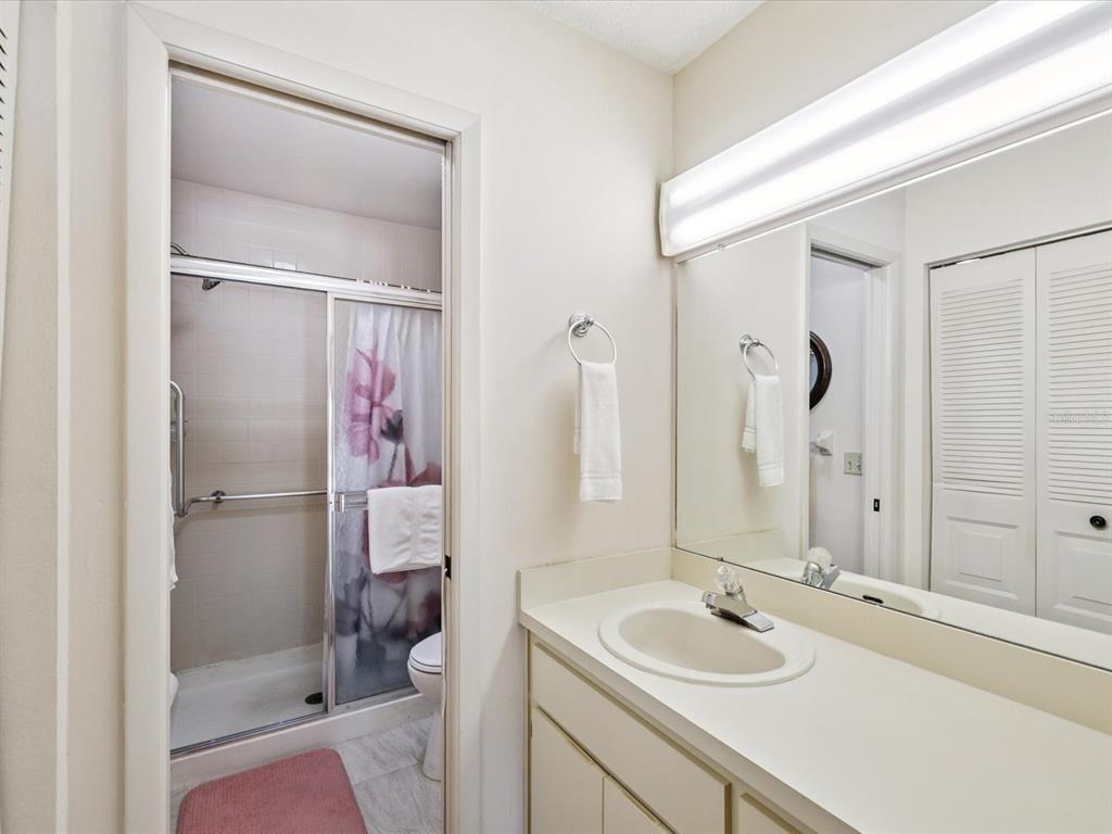 12141 Spartan Way, Unit 202 Hudson, FL 34667 - Photo 27 of 45 a bathroom with a sink a toilet and shower