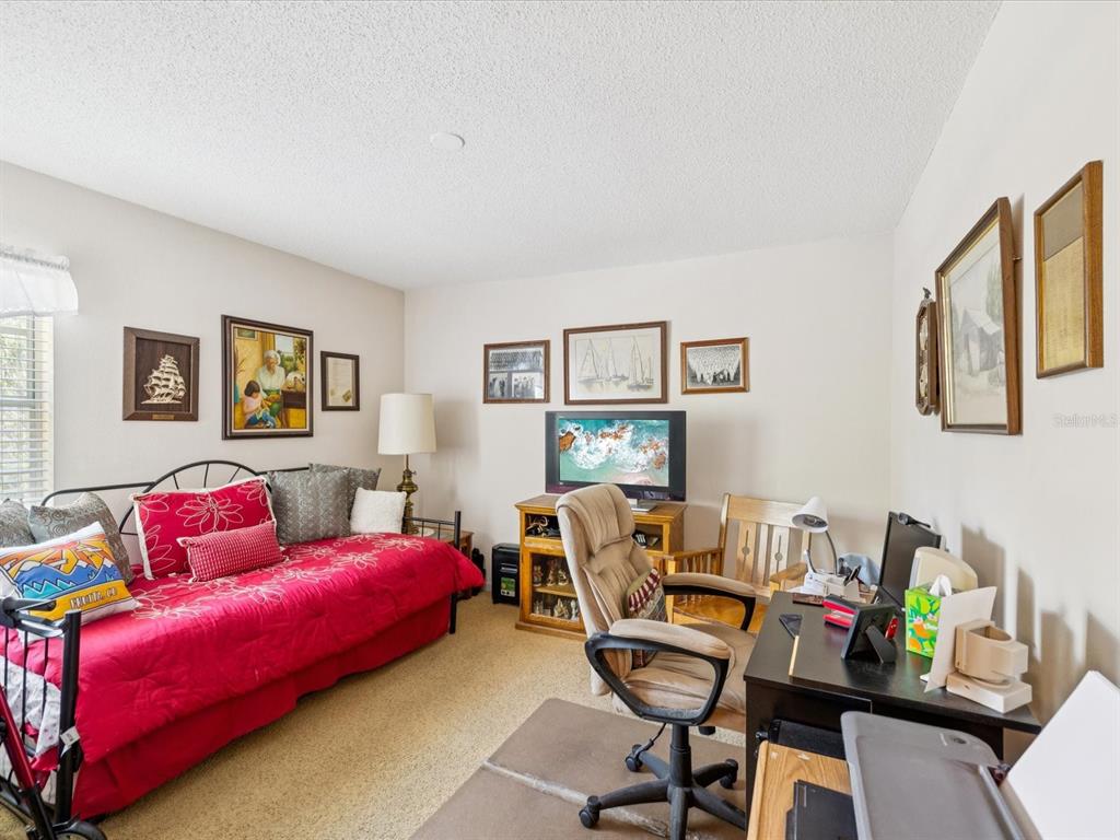 12141 Spartan Way, Unit 202 Hudson, FL 34667 - Photo 29 of 45 a living room with furniture and a wooden floor