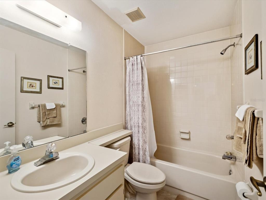 12141 Spartan Way, Unit 202 Hudson, FL 34667 - Photo 30 of 45 a bathroom with a sink toilet and shower