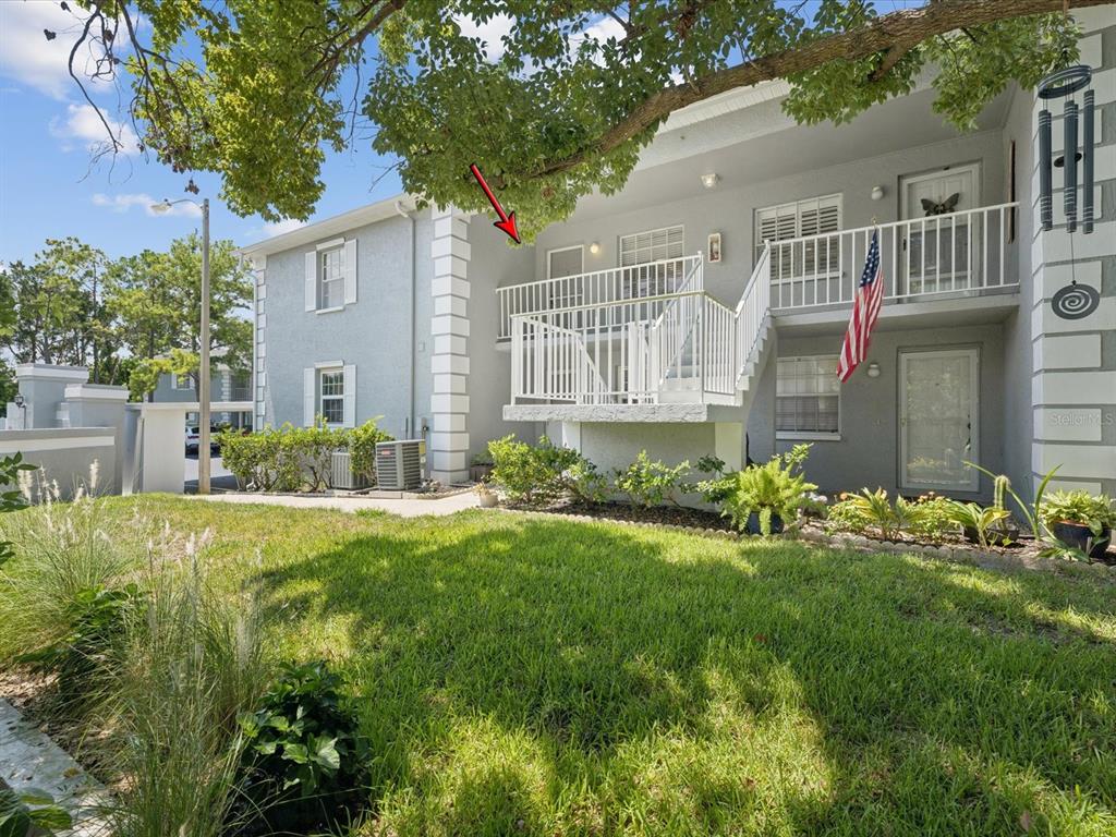 12141 Spartan Way, Unit 202 Hudson, FL 34667 - Photo 36 of 45 a front view of a house with garden