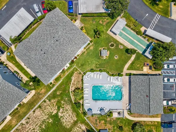 an aerial view of a house with a swimming pool yard and outdoor seating