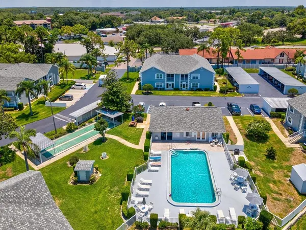 an aerial view of multiple houses with a yard