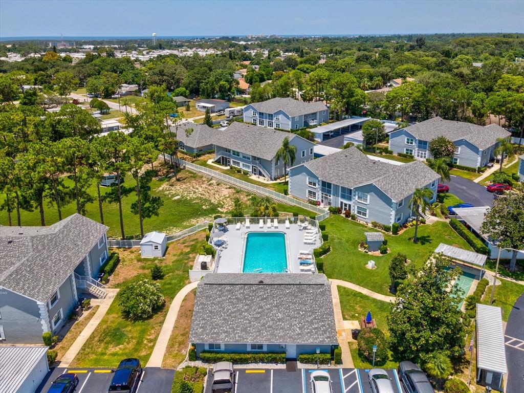 12141 Spartan Way, Unit 202 Hudson, FL 34667 - Photo 39 of 45 an aerial view of multiple houses with a yard