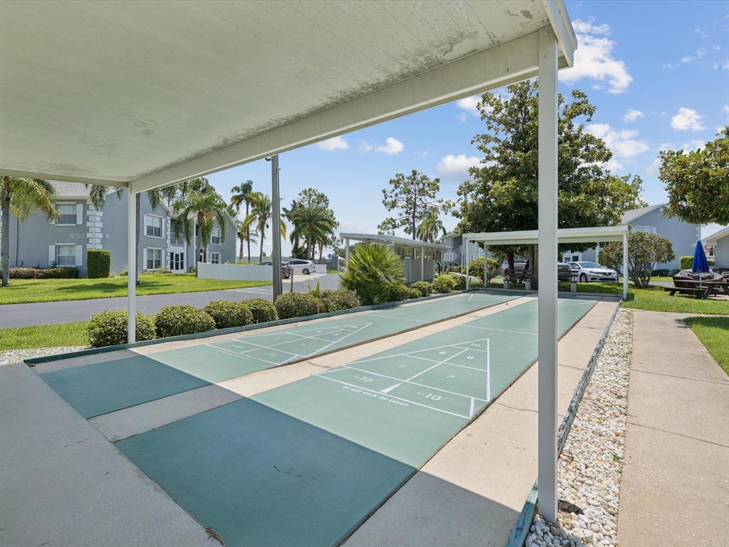 12141 Spartan Way, Unit 202 Hudson, FL 34667 - Photo 42 of 45 a view of a swimming pool with an outdoor seating