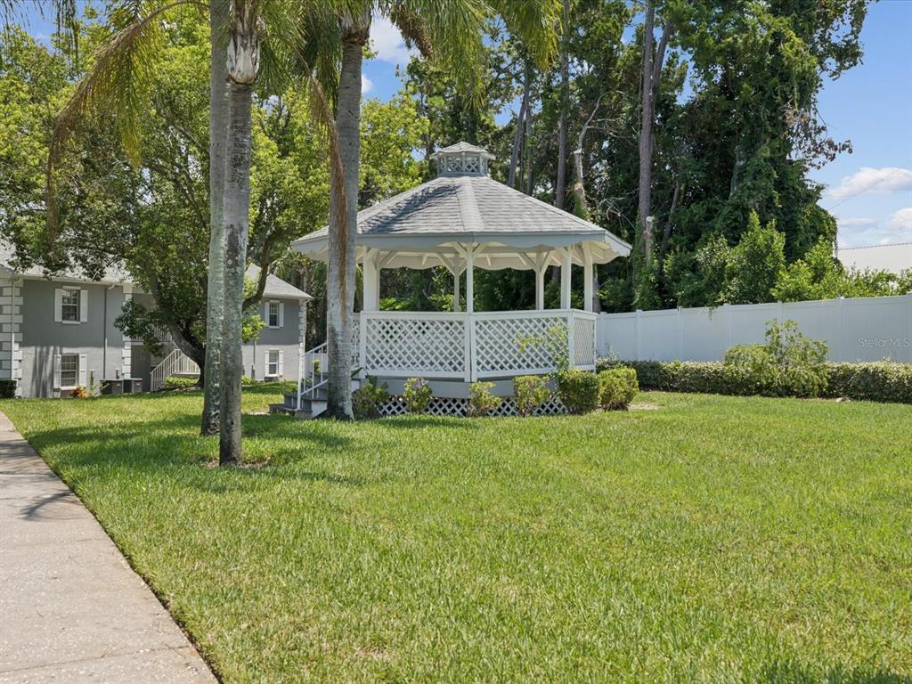 12141 Spartan Way, Unit 202 Hudson, FL 34667 - Photo 45 of 45 a front view of a house with garden