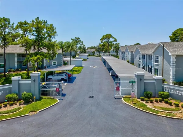 a view of a patio with table and chairs with wooden floor and fence