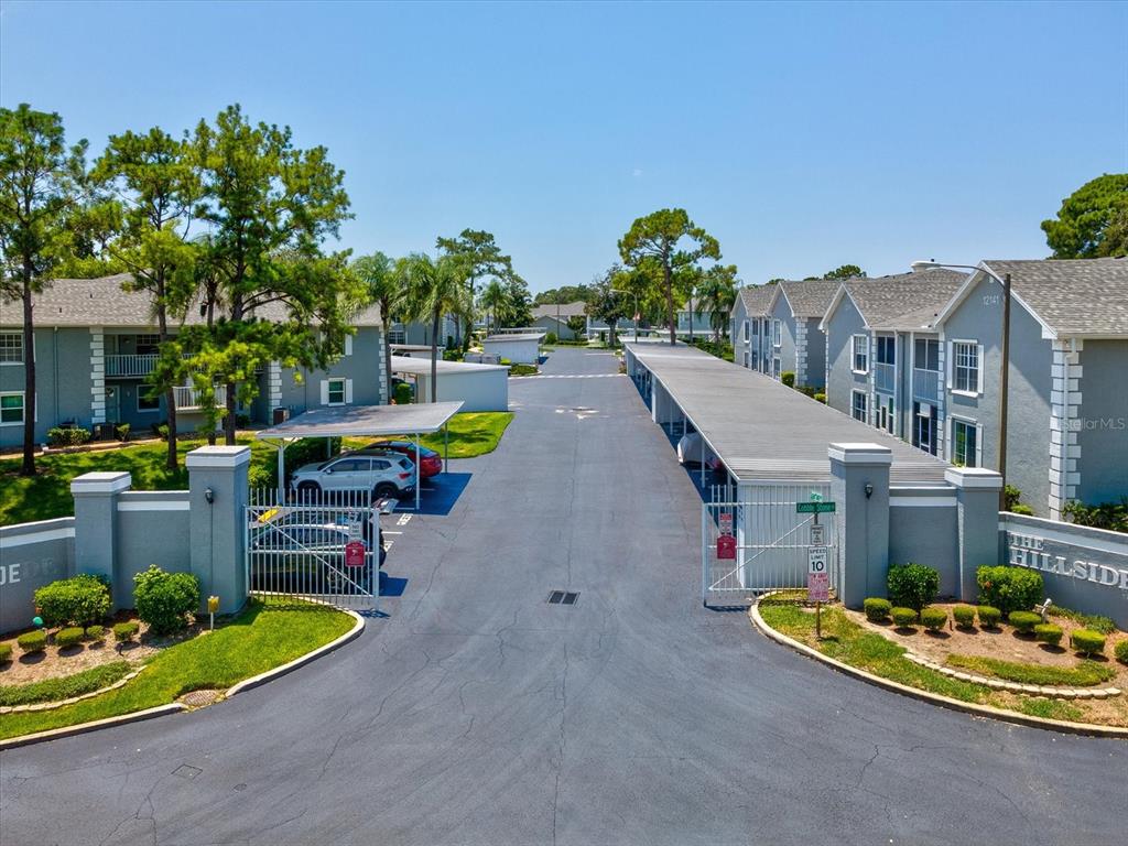 12141 Spartan Way, Unit 202 Hudson, FL 34667 - Photo 8 of 45 a swimming pool with outdoor seating and yard