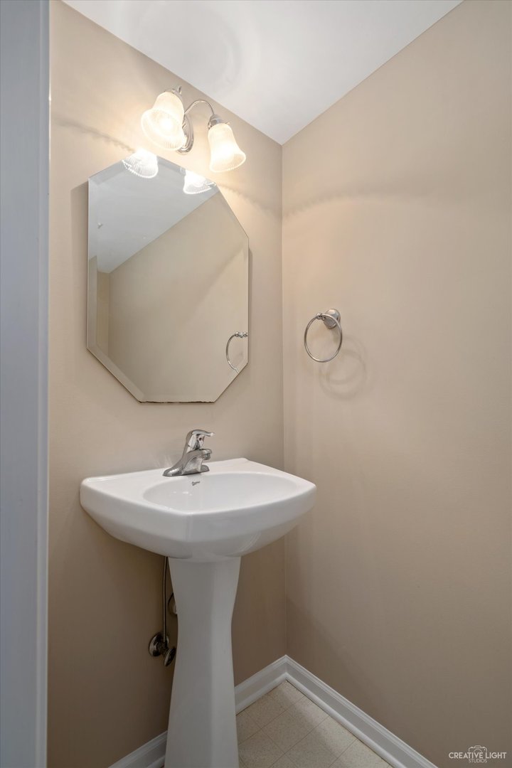 47 Rolling Oaks Road, Unit F Sugar Grove, IL 60554 - Photo 12 of 21 a bathroom with a sink a mirror and vanity