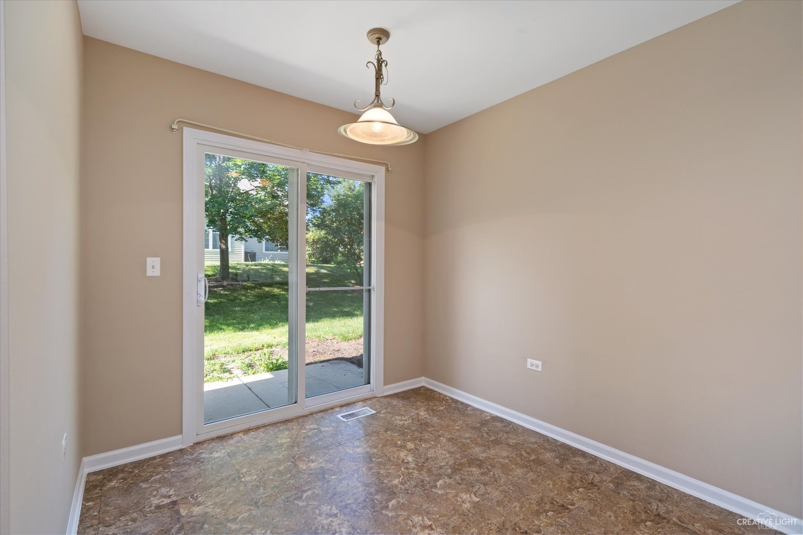 47 Rolling Oaks Road, Unit F Sugar Grove, IL 60554 - Photo 10 of 21 a view of an empty room with wooden floor and a window