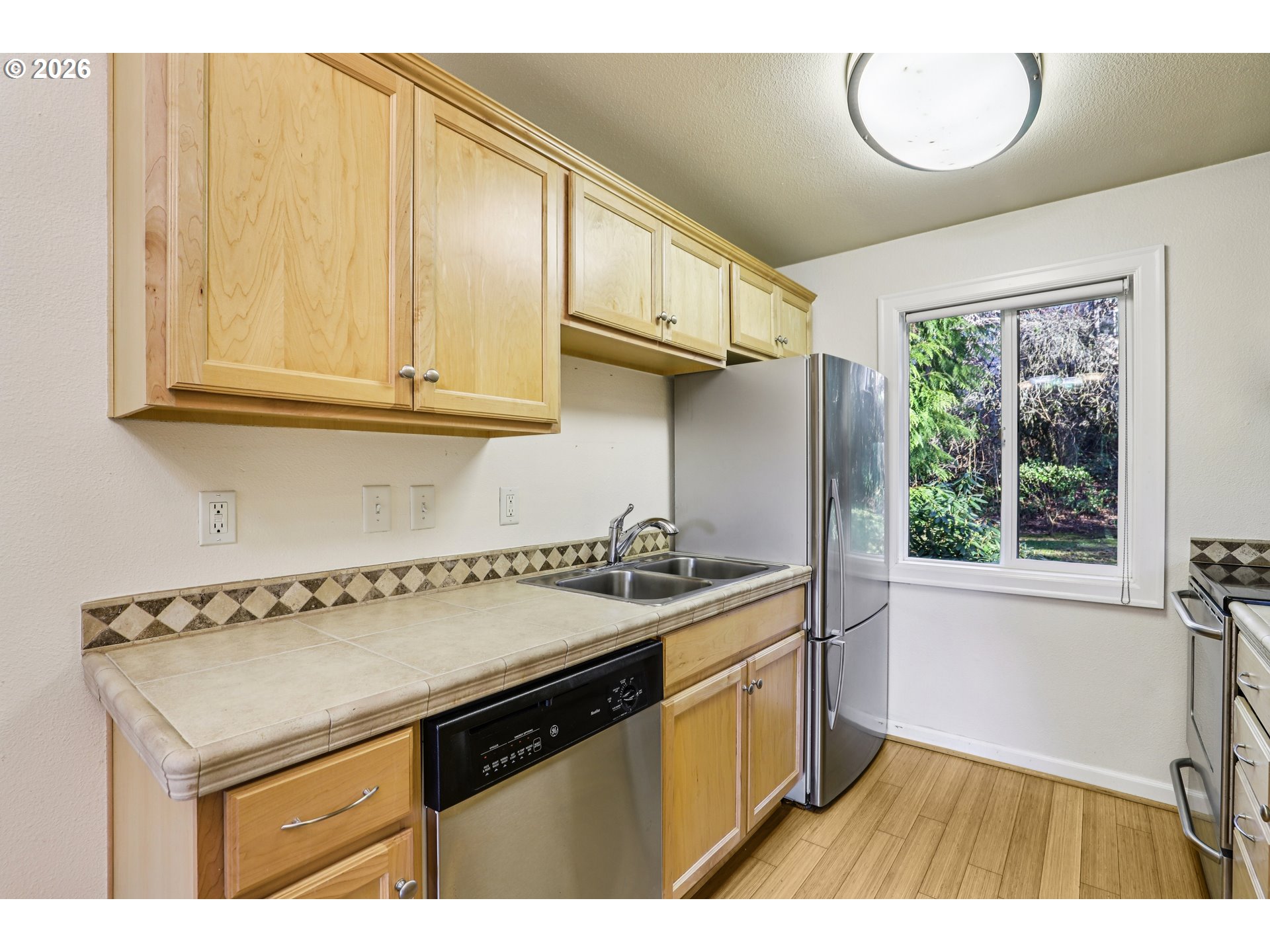 2680 Southwest 87th Avenue, Unit 5 Portland, OR 97225 - Photo 6 of 25 a kitchen with a sink a stove cabinets and a window