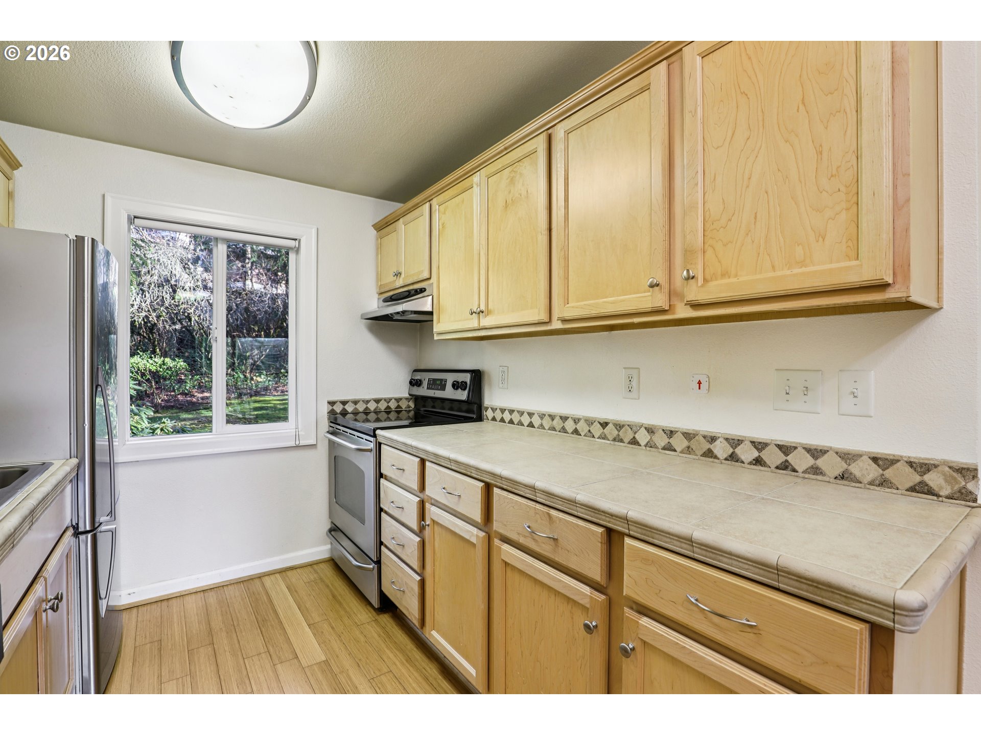 2680 Southwest 87th Avenue, Unit 5 Portland, OR 97225 - Photo 7 of 25 a kitchen with a sink a stove and cabinets