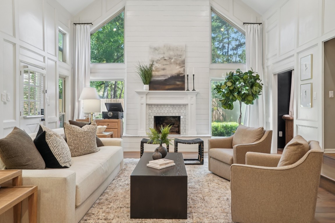 8307 Ash Valley Drive Spring, TX 77379 - Photo 11 of 48 Large living room with soaring ceilings, large windows and marble accents on the fireplace