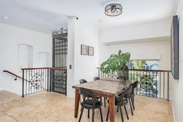 a view of a dining room with furniture and a potted plant