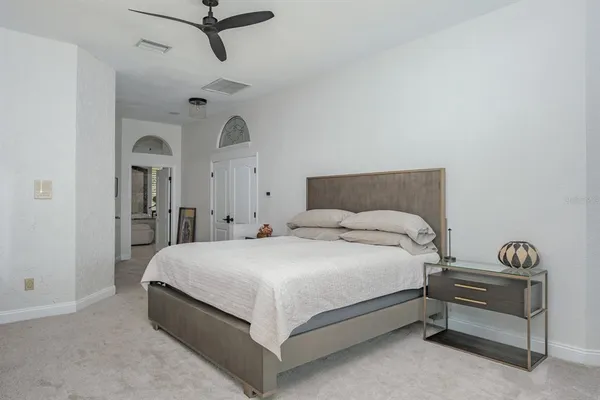 a bedroom with a bed and a chandelier