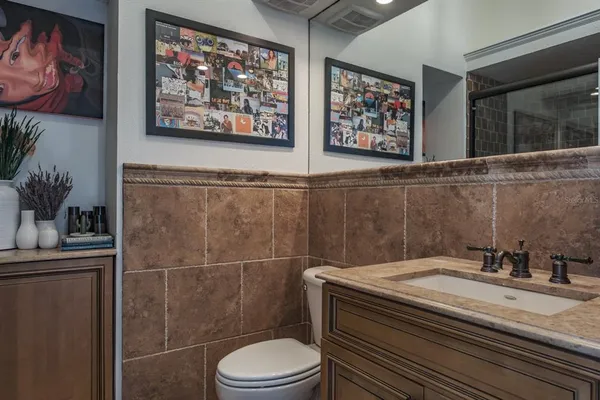a bathroom with a toilet a sink and mirror