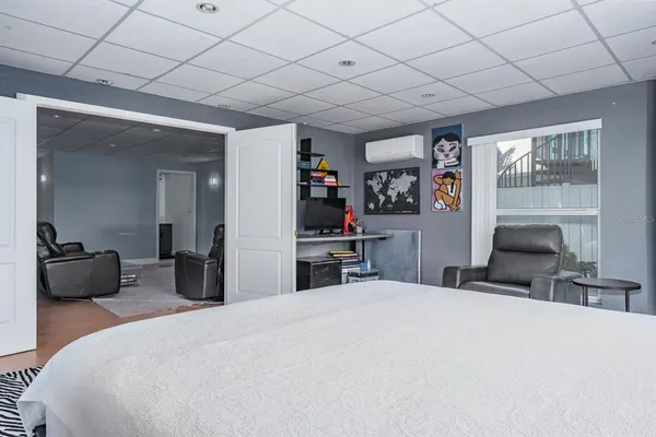 a bedroom with a bed and a large mirror