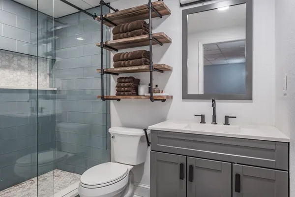 a bathroom with a sink toilet and shower
