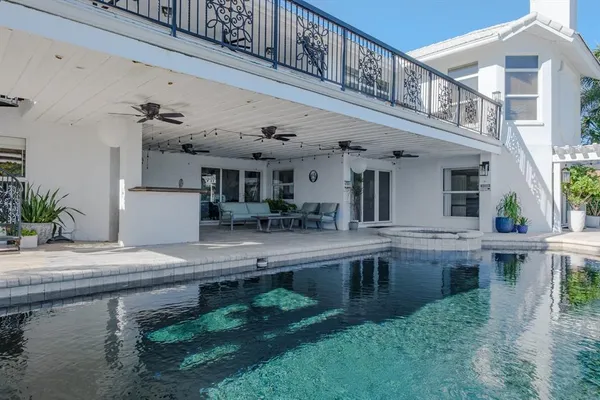 a view of a house with pool and chairs
