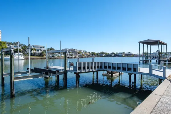 a view of a roof deck with table and chairs a barbeque