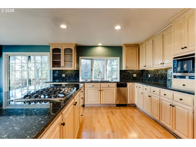 a view of a living room and kitchen with wooden floor