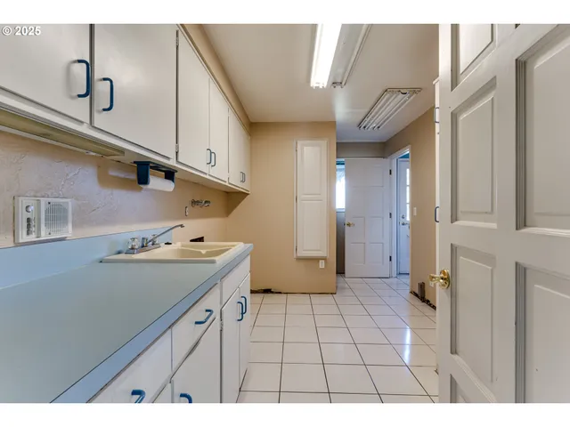 a bathroom with a sink and a refrigerator