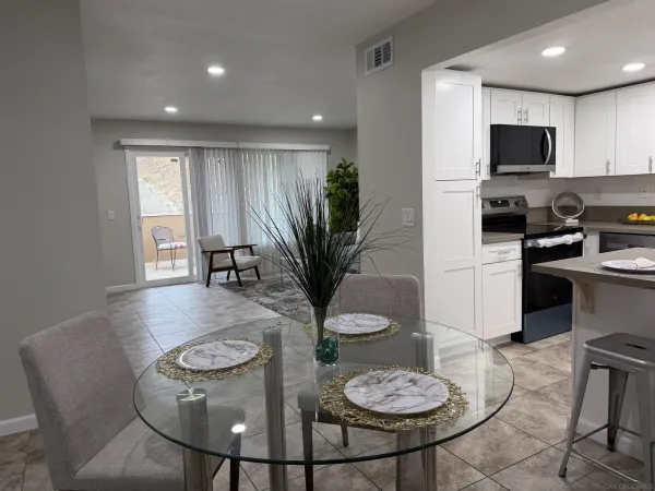 a kitchen with a table and chairs in it