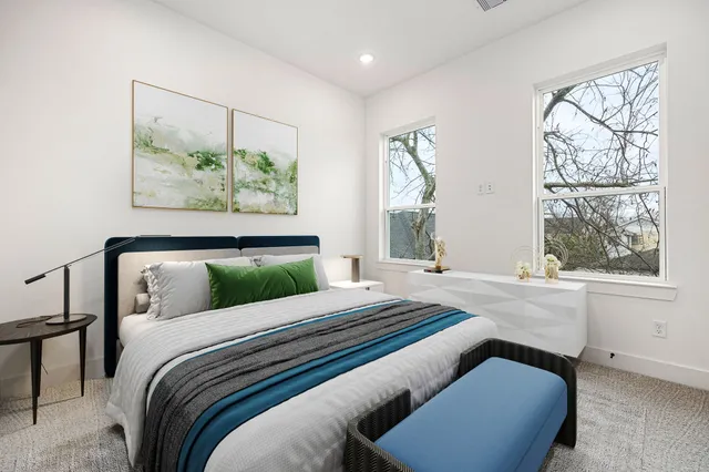 a bedroom with a bed and a painting on the wall