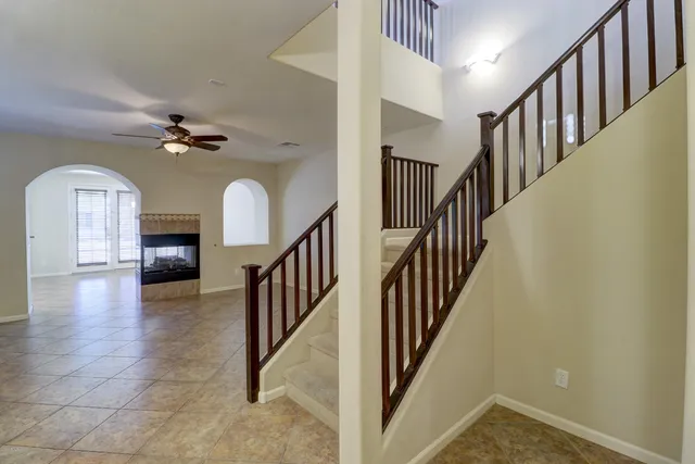 a view of staircase with wooden floor and a chandelier