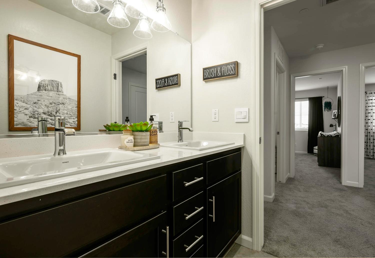 63 Blueberry Lane, Unit 5 Merced, CA 95341 - Photo 21 of 28 a bathroom with a double vanity sink and a mirror