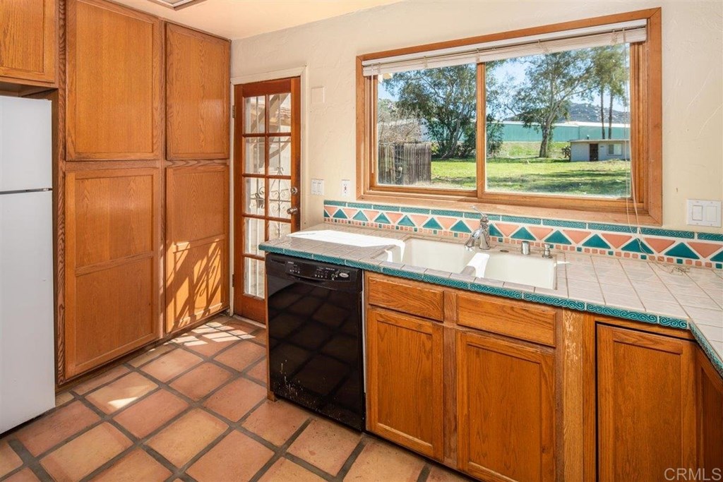 2061 Sycamore Drive San Marcos, CA 92069 - Photo 11 of 27 a bathroom with a sink and a large mirror