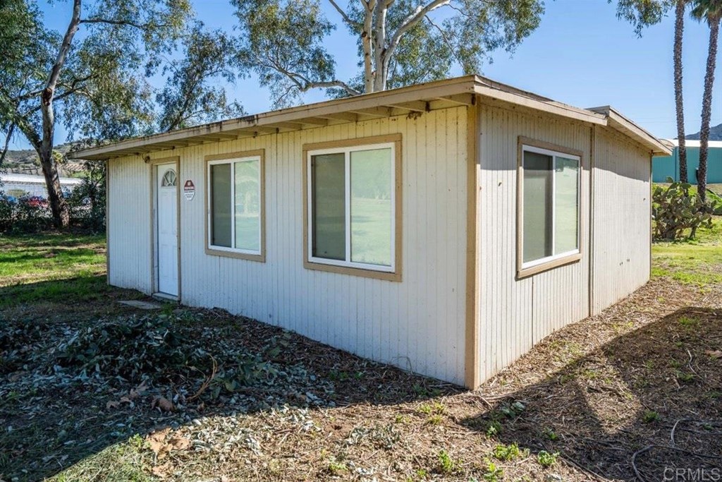 2061 Sycamore Drive San Marcos, CA 92069 - Photo 25 of 27 a view of a house with backyard and trees