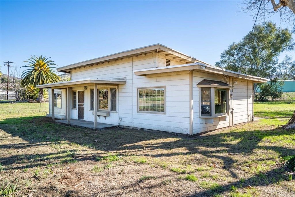2061 Sycamore Drive San Marcos, CA 92069 - Photo 4 of 27 a front view of a house with a yard