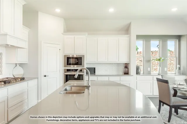 a kitchen with stainless steel appliances a refrigerator sink and microwave