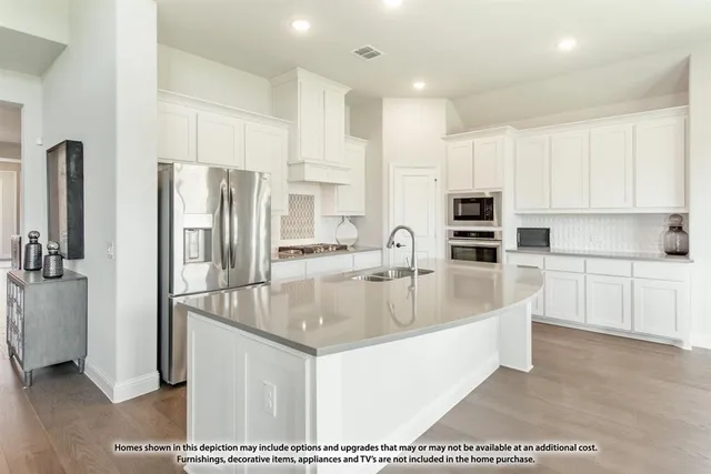 a kitchen with stainless steel appliances granite countertop a sink and a refrigerator