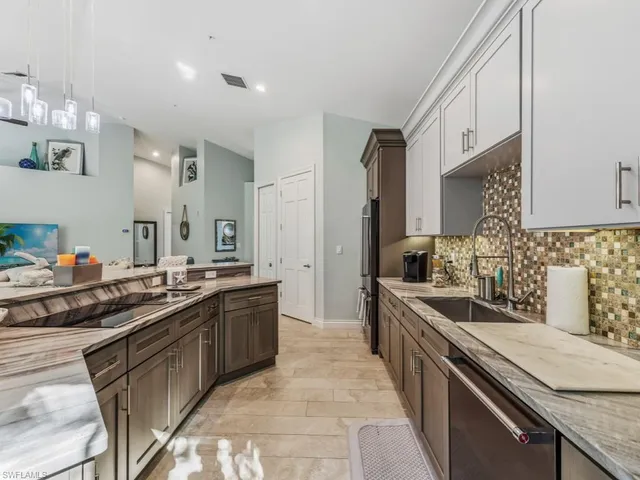 a kitchen with a sink stove and cabinets