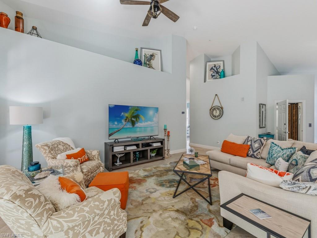 175 Colonade Circle Naples, FL 34103 - Photo 18 of 45 a living room with furniture and a flat screen tv