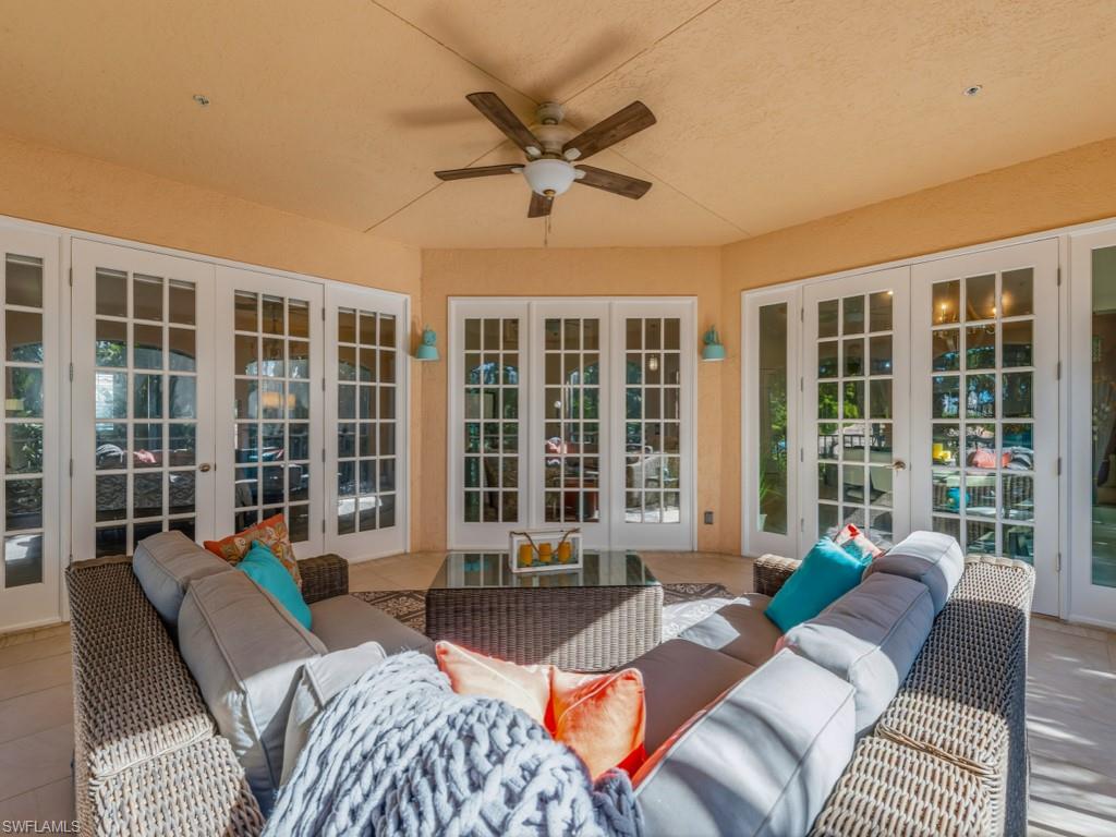 175 Colonade Circle Naples, FL 34103 - Photo 22 of 45 a living room with furniture and floor to ceiling windows