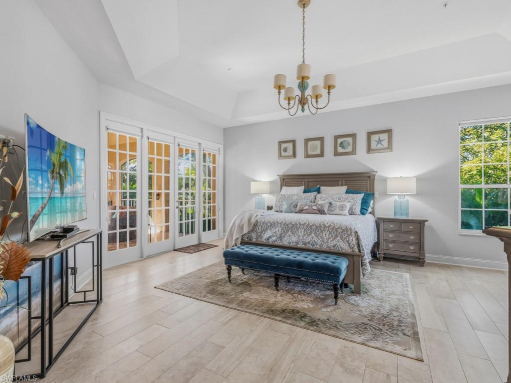 175 Colonade Circle Naples, FL 34103 - Photo 23 of 45 a spacious bedroom with a bed and a large window