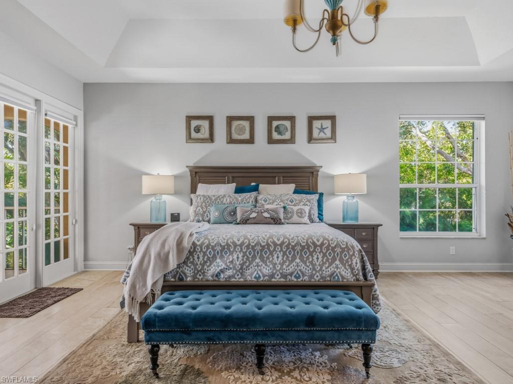 175 Colonade Circle Naples, FL 34103 - Photo 24 of 45 a bed sitting in a bedroom next to a window