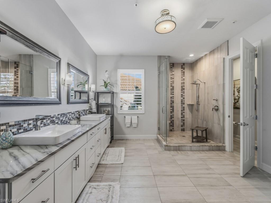 175 Colonade Circle Naples, FL 34103 - Photo 26 of 45 a bathroom with a granite countertop sink a toilet a mirror and shower