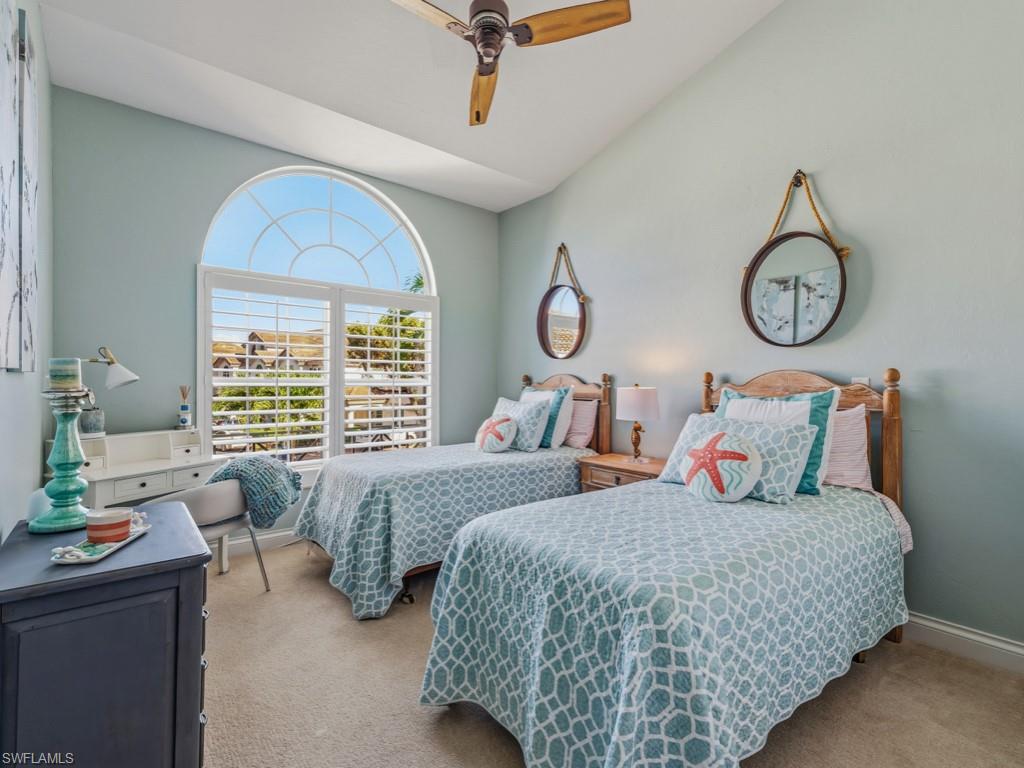 175 Colonade Circle Naples, FL 34103 - Photo 27 of 45 a bedroom with bed and a large window