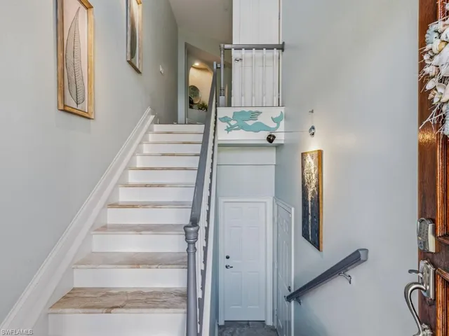 a view of staircase with white walls and a window