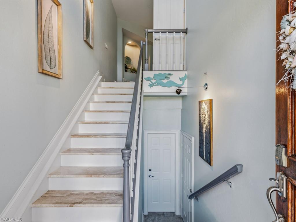 175 Colonade Circle Naples, FL 34103 - Photo 4 of 45 a view of staircase with white walls and a window